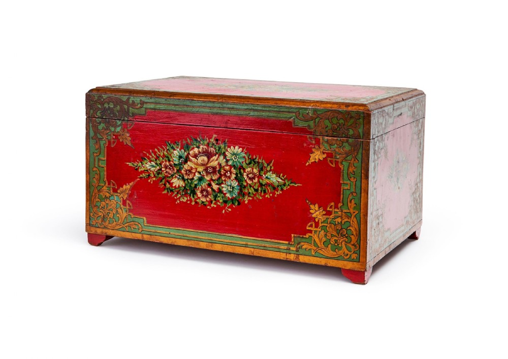 A rectangular 19th-century Persian lacquer cashier box featuring a bright red painted front decorated with a central floral bouquet and green and gold corner foliage.