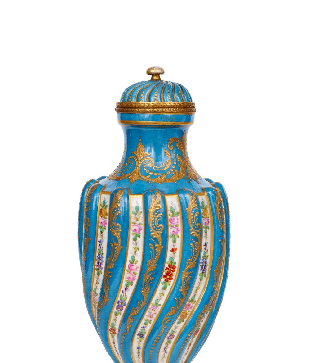 A 19th-century Sevres style sky blue and gilt porcelain vase with a cover, featuring spiralled flutes decorated with floral painted garlands. View II