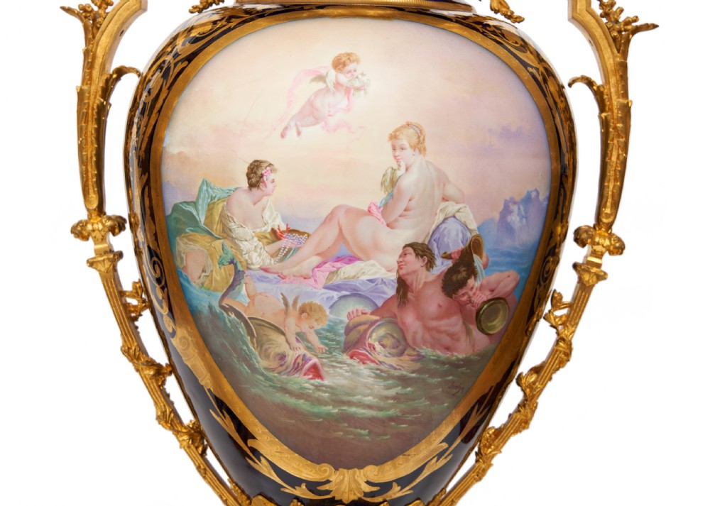 A pair of large French Sevres style cobalt blue porcelain lidded urns featuring hand-painted mythological scenes and elaborate gilded ormolu handles. View XI