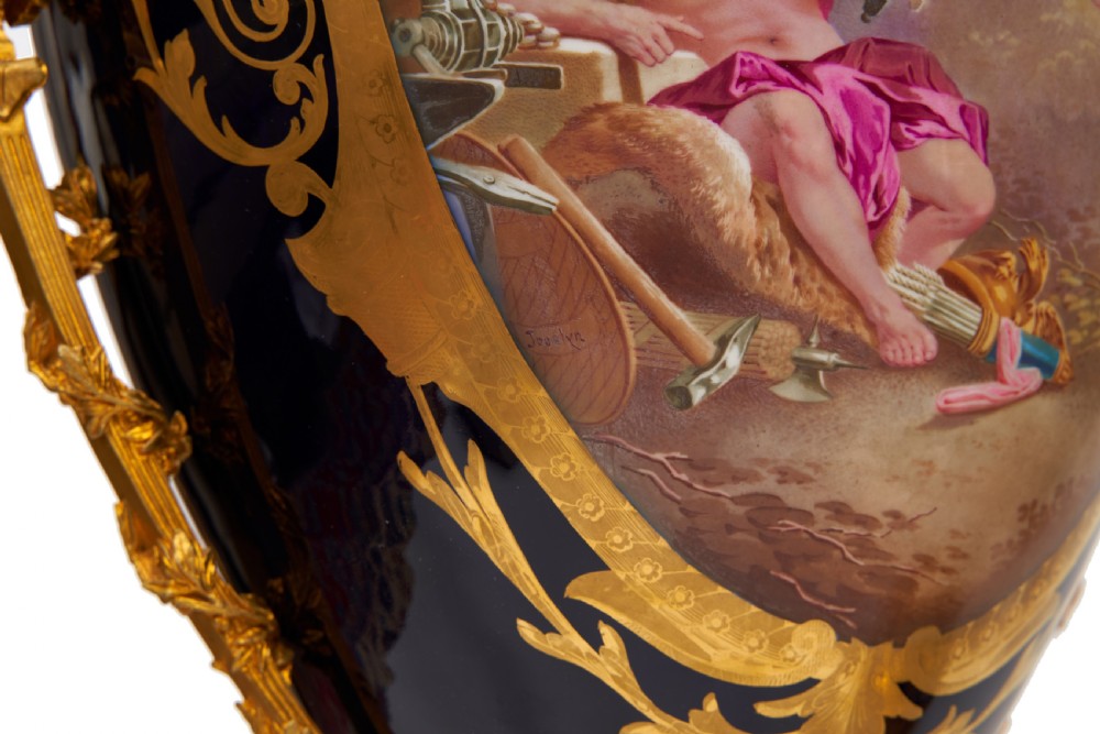 A pair of large French Sevres style cobalt blue porcelain lidded urns featuring hand-painted mythological scenes and elaborate gilded ormolu handles. View XV