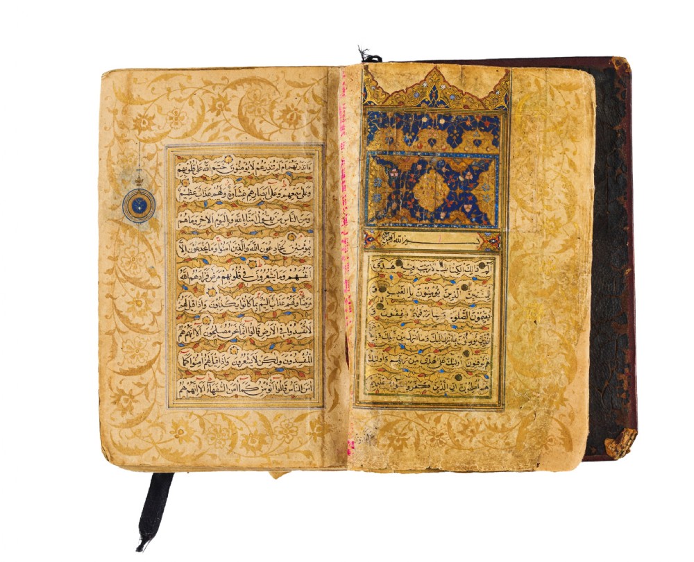 An open fifteenth-century Persian Timurid Quran manuscript featuring gold leaf and lapis lazuli blue arabesque illuminated frontispiece panels with Arabic calligraphy. View IV