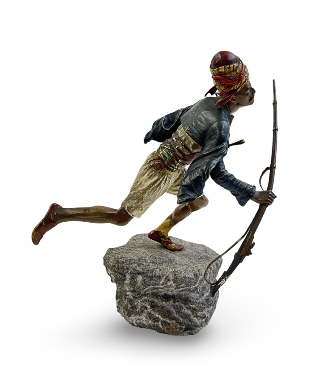 A cold-painted bronze figure depicting a Moorish warrior in motion on a faux rock base, holding a long rifle. View II