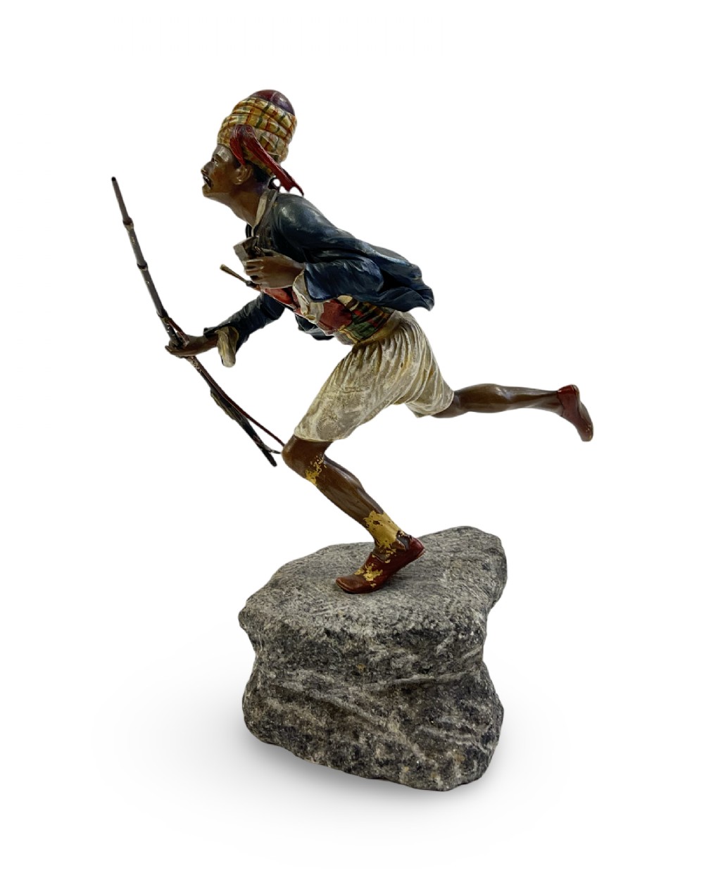 A cold-painted bronze figure depicting a Moorish warrior in motion on a faux rock base, holding a long rifle. View IV