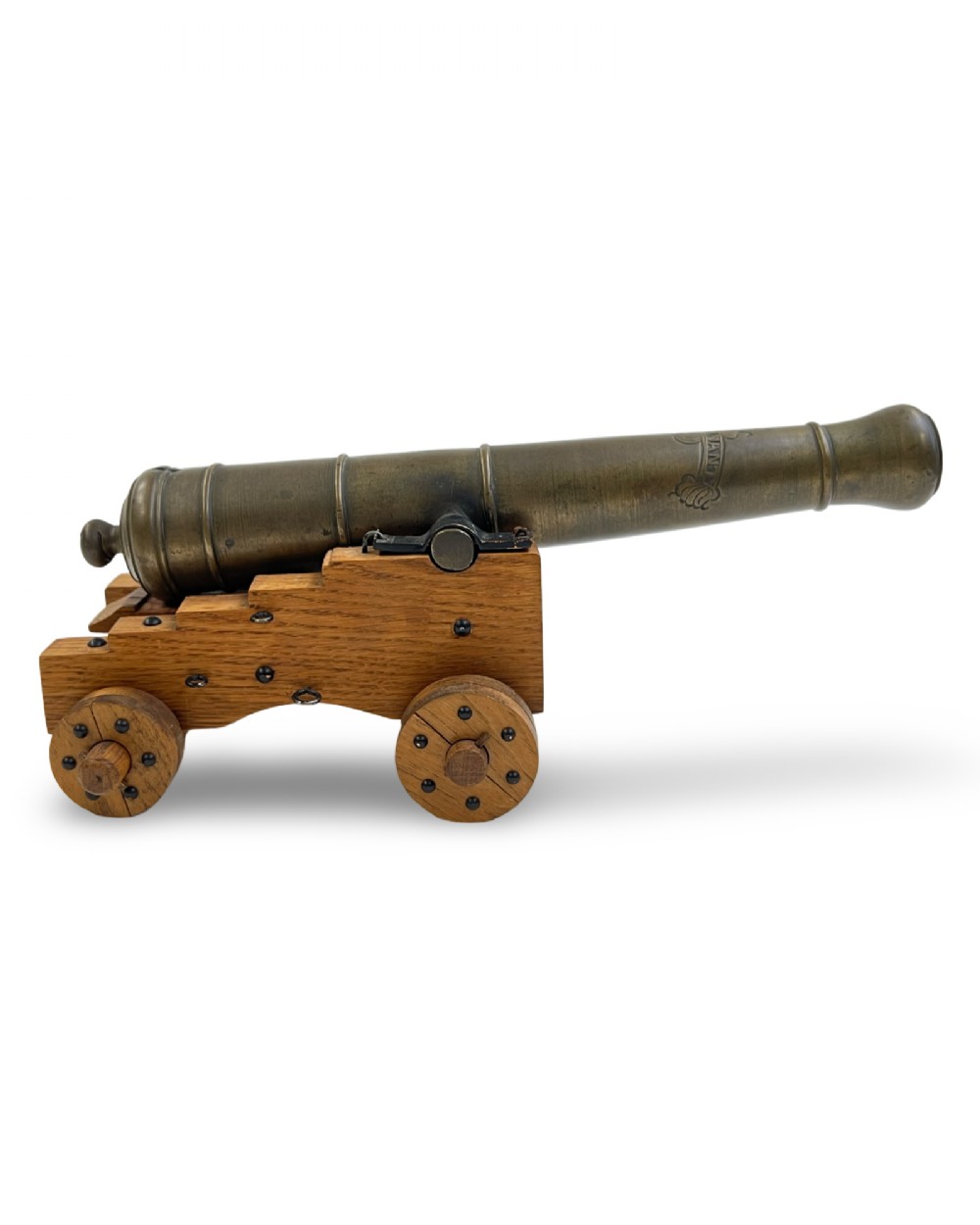 A small cast bronze signal cannon barrel with etched inscriptions mounted on a wooden stepped carriage with four wheels. View II