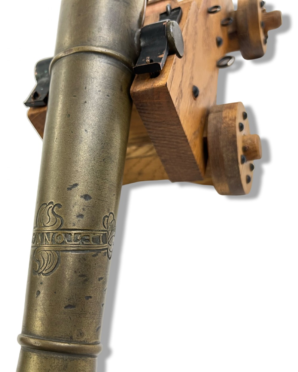 A small cast bronze signal cannon barrel with etched inscriptions mounted on a wooden stepped carriage with four wheels. View VII