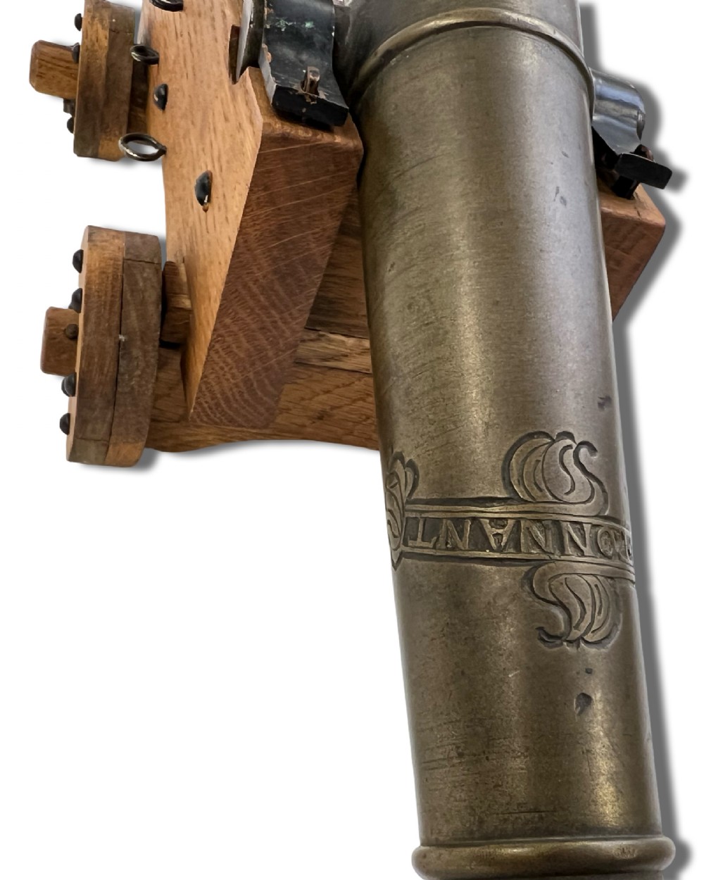 A small cast bronze signal cannon barrel with etched inscriptions mounted on a wooden stepped carriage with four wheels. View VIII