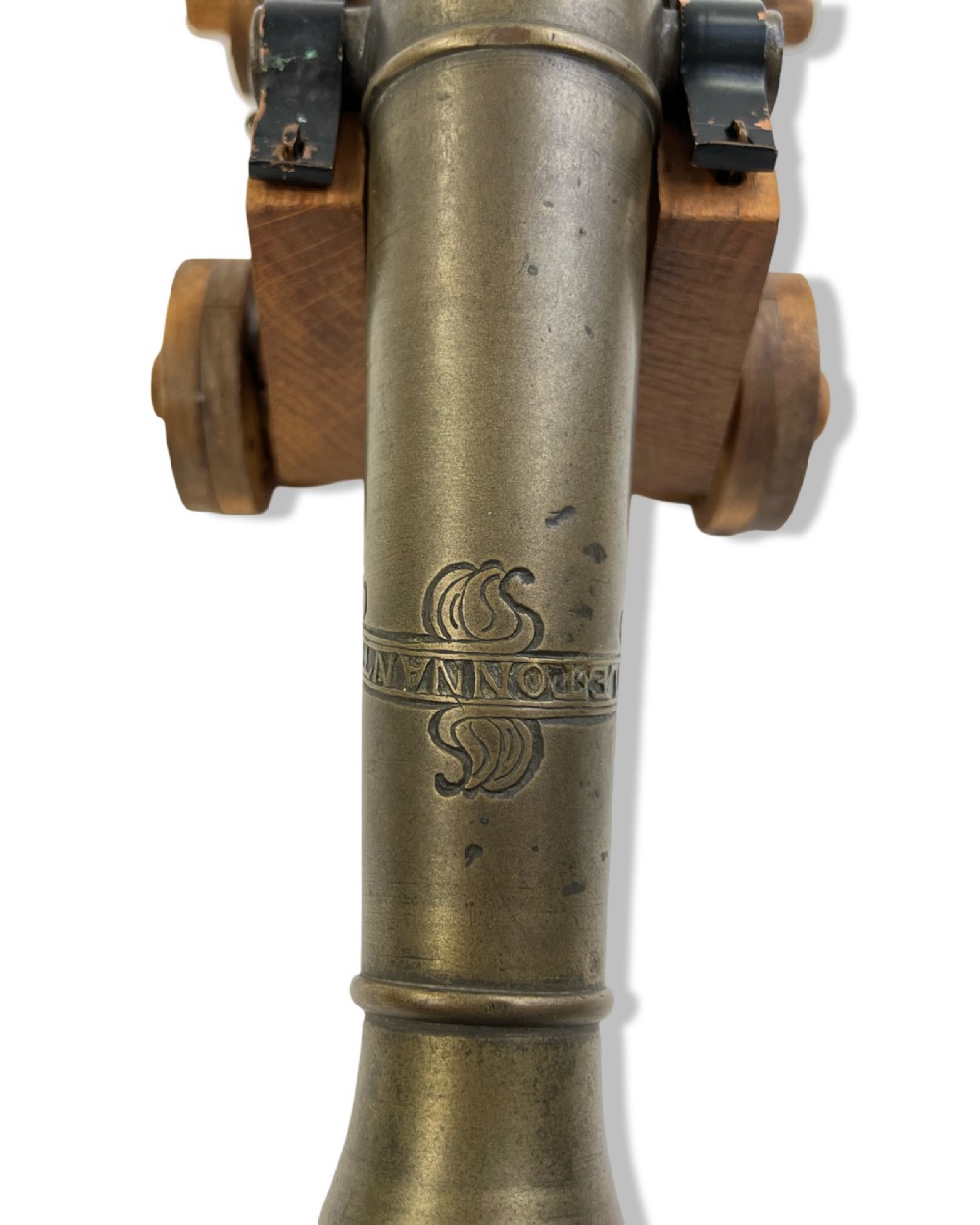 A small cast bronze signal cannon barrel with etched inscriptions mounted on a wooden stepped carriage with four wheels. View IX