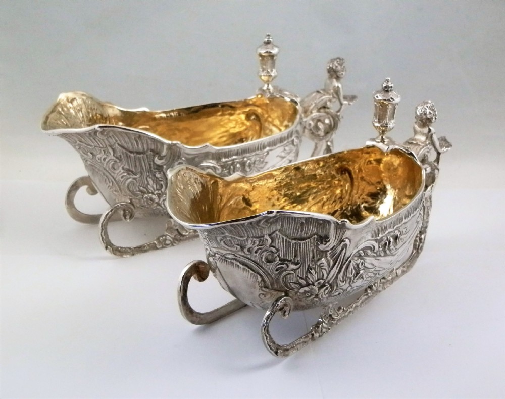 A pair of late Victorian sterling silver sleigh-shaped sauce boats with ornate rococo repousse detailing and gilded interiors. View III