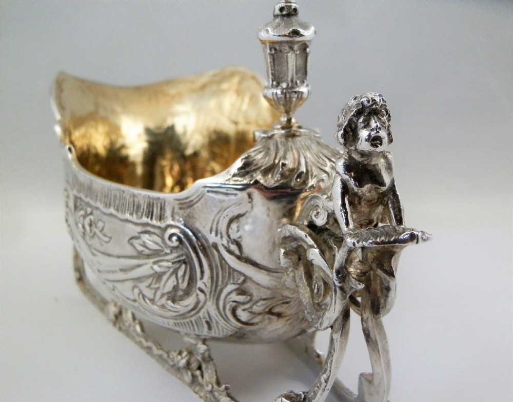 A pair of late Victorian sterling silver sleigh-shaped sauce boats with ornate rococo repousse detailing and gilded interiors. View VI