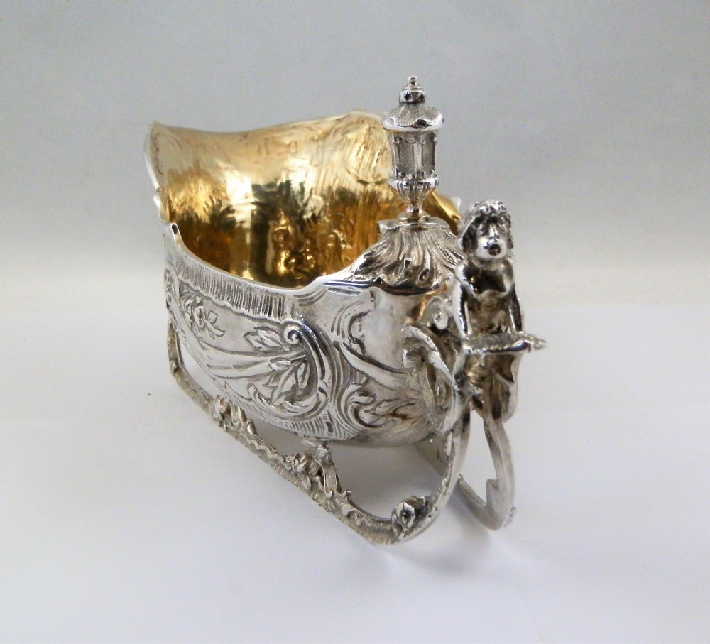 A pair of late Victorian sterling silver sleigh-shaped sauce boats with ornate rococo repousse detailing and gilded interiors. View VII