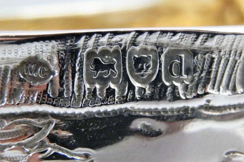 A pair of late Victorian sterling silver sleigh-shaped sauce boats with ornate rococo repousse detailing and gilded interiors. View IX