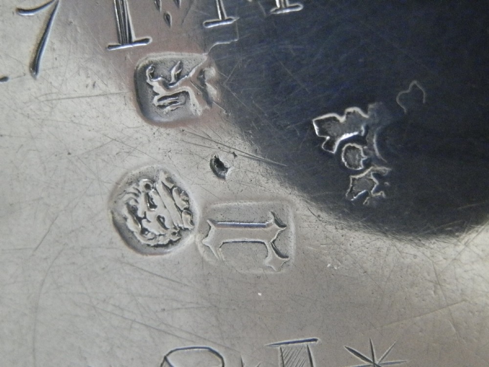 A 1694 William and Mary sterling silver porringer with twin scroll handles, rope-moulded girdle, lower spiral fluting, and an engraved armorial crest. View VIII