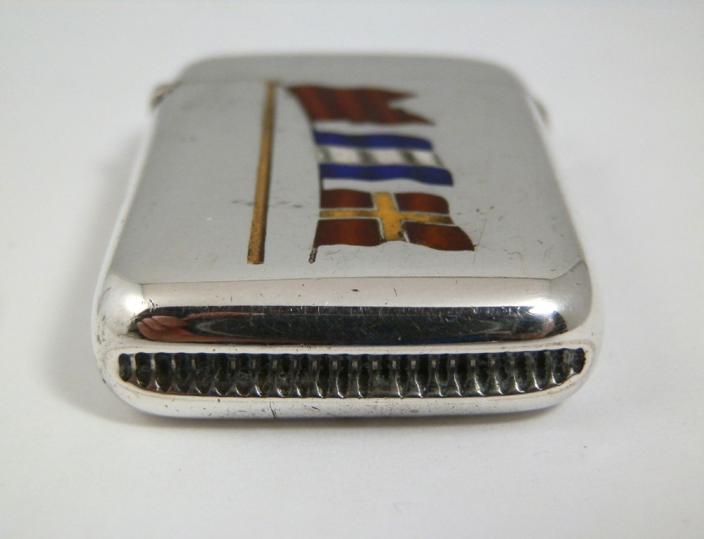 A Victorian sterling silver vesta case decorated with an enamelled nautical signal flag design on the front. View V