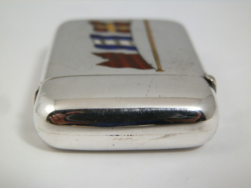 A Victorian sterling silver vesta case decorated with an enamelled nautical signal flag design on the front. View VI