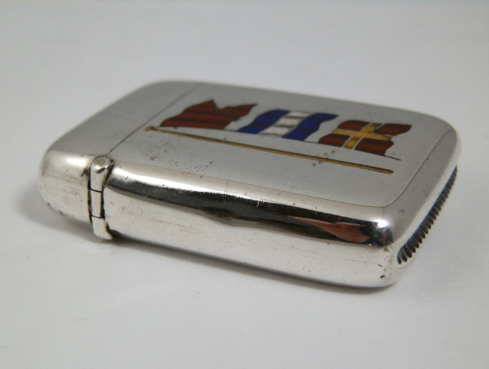 A Victorian sterling silver vesta case decorated with an enamelled nautical signal flag design on the front. View VIII