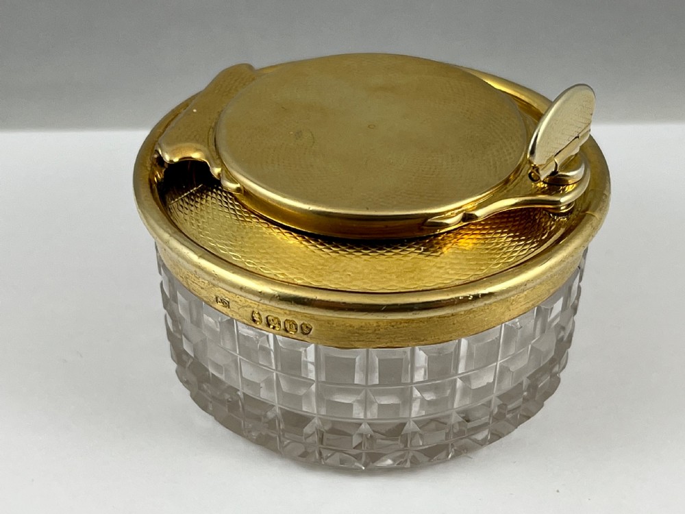 A circular George IV cut glass travelling inkwell with an engine-turned silver gilt lid and latch mechanism. View III