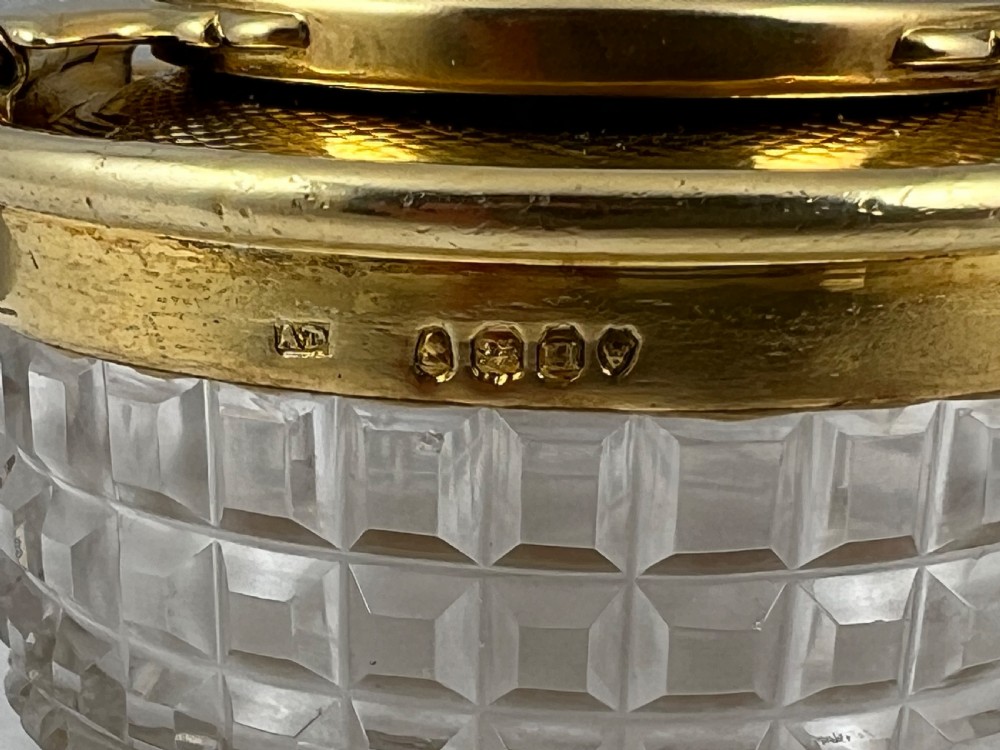 A circular George IV cut glass travelling inkwell with an engine-turned silver gilt lid and latch mechanism. View V
