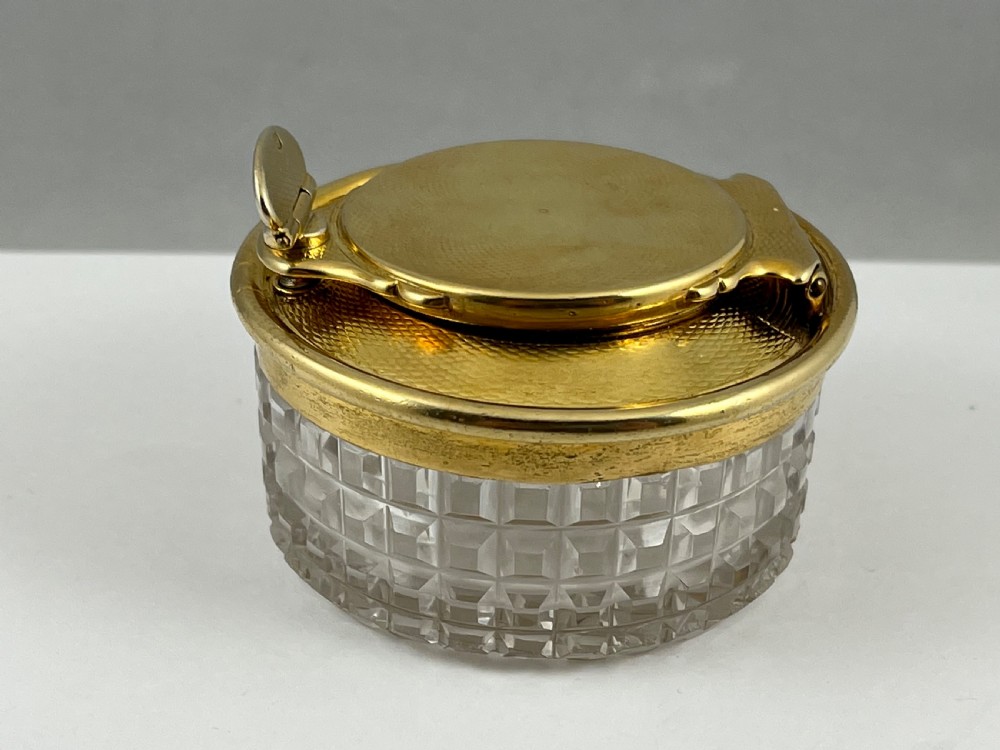 A circular George IV cut glass travelling inkwell with an engine-turned silver gilt lid and latch mechanism. View VI