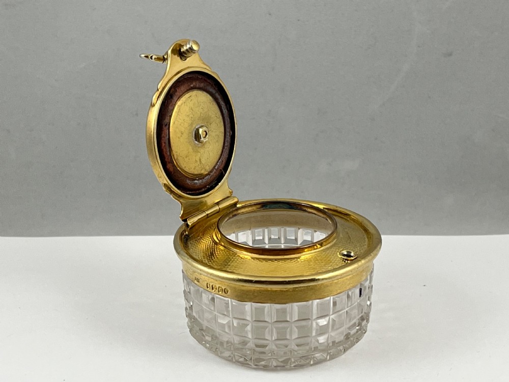 A circular George IV cut glass travelling inkwell with an engine-turned silver gilt lid and latch mechanism. View VIII