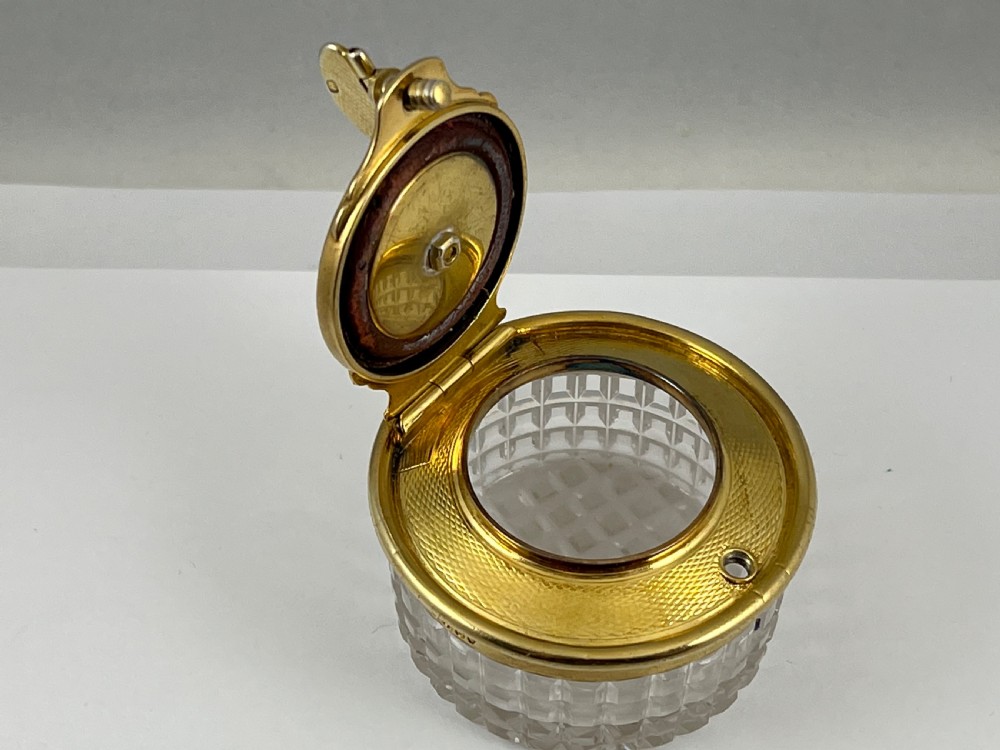 A circular George IV cut glass travelling inkwell with an engine-turned silver gilt lid and latch mechanism. View IX