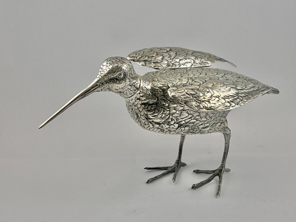 An antique silver woodcock figure depicted standing with realistic chased feather detailing and a long slender beak. View II