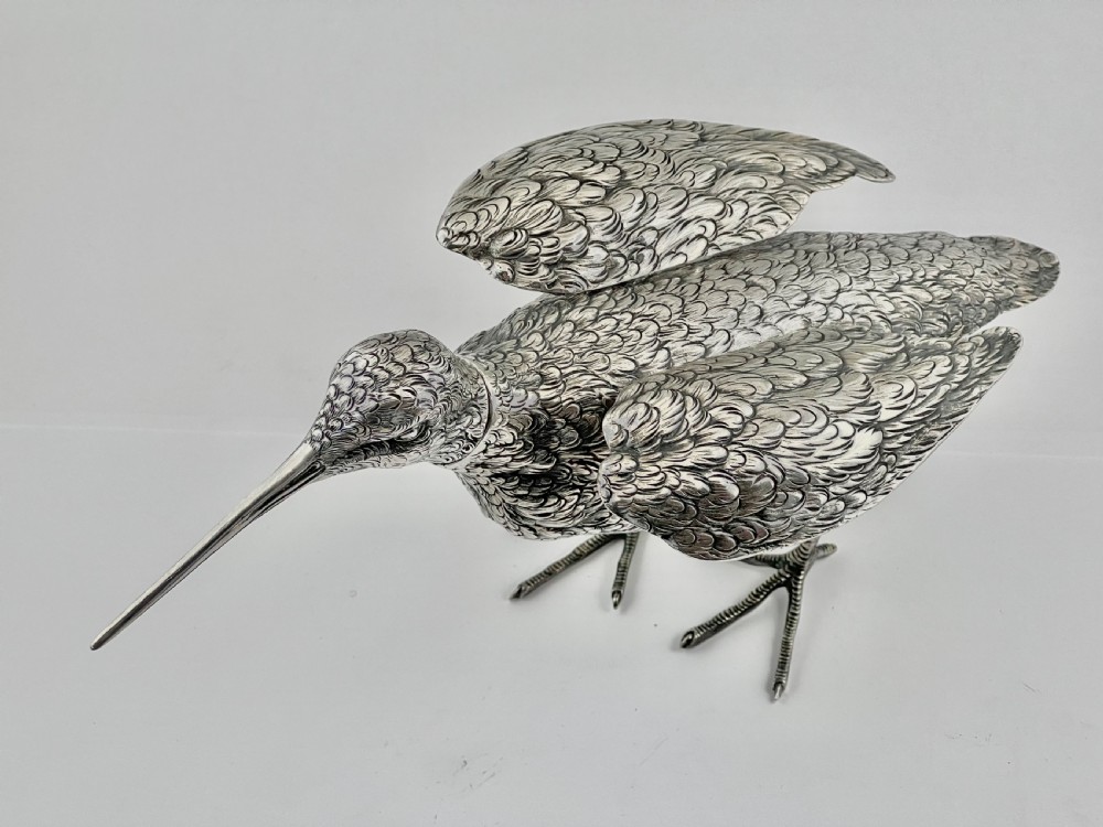 An antique silver woodcock figure depicted standing with realistic chased feather detailing and a long slender beak. View III