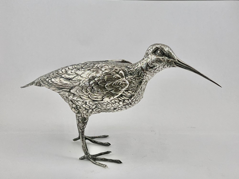An antique silver woodcock figure depicted standing with realistic chased feather detailing and a long slender beak. View V
