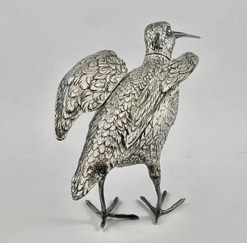 An antique silver woodcock figure depicted standing with realistic chased feather detailing and a long slender beak. View VI