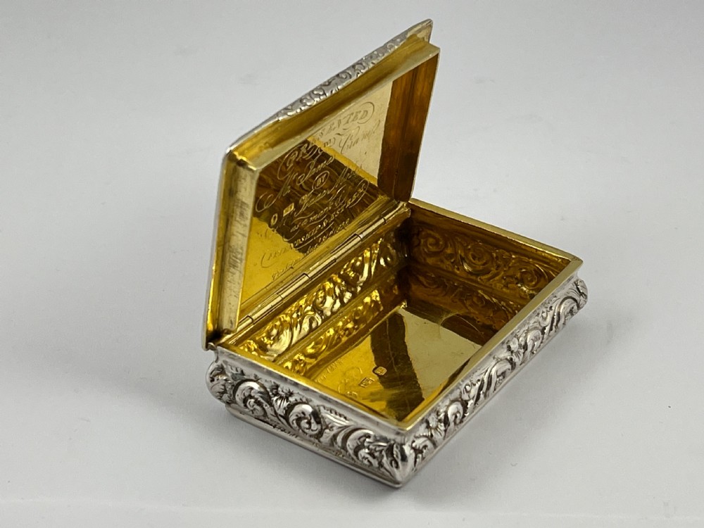 Rectangular sterling silver snuff box featuring a relief-carved hunting scene with a rider on horseback surrounded by hounds in a woodland setting. View IX