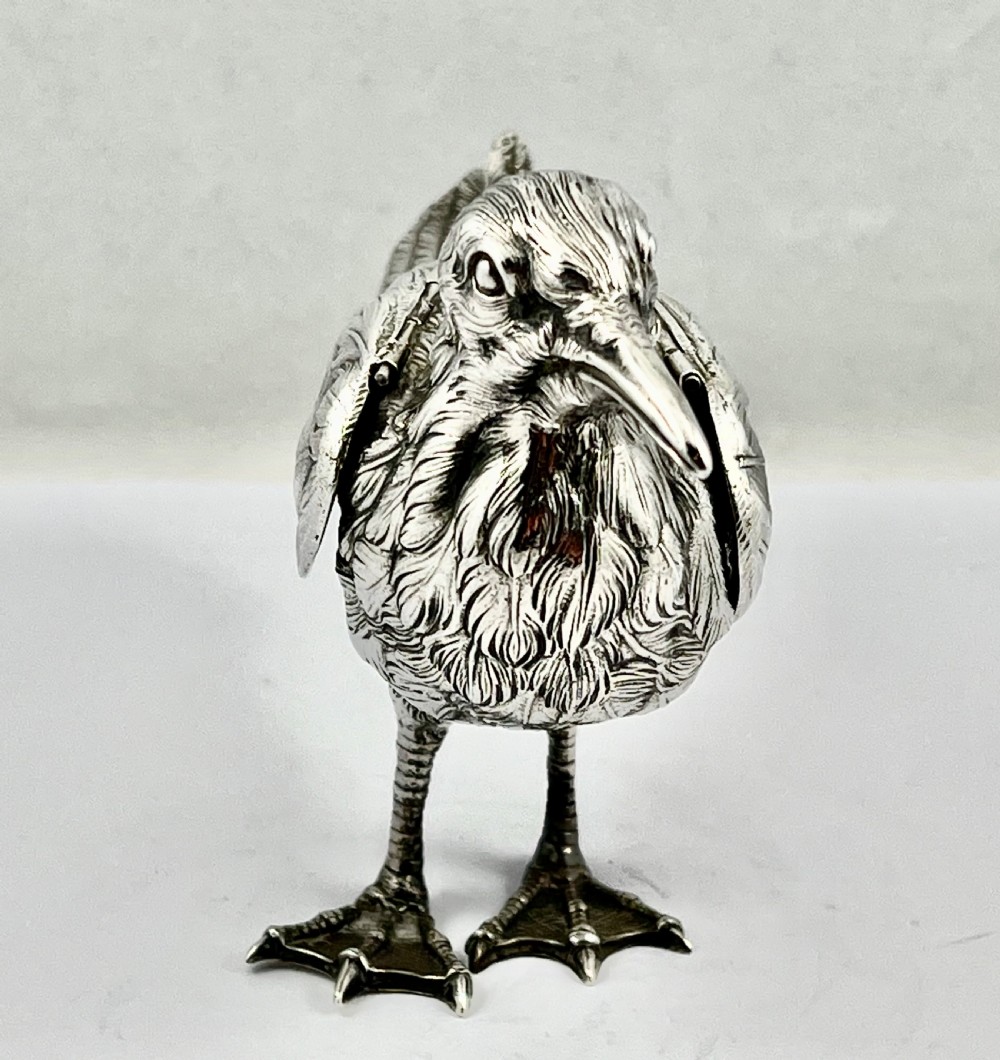 A chased Edwardian silver model of a wading bird with textured feather detail and webbed feet, shown in profile facing left. View II
