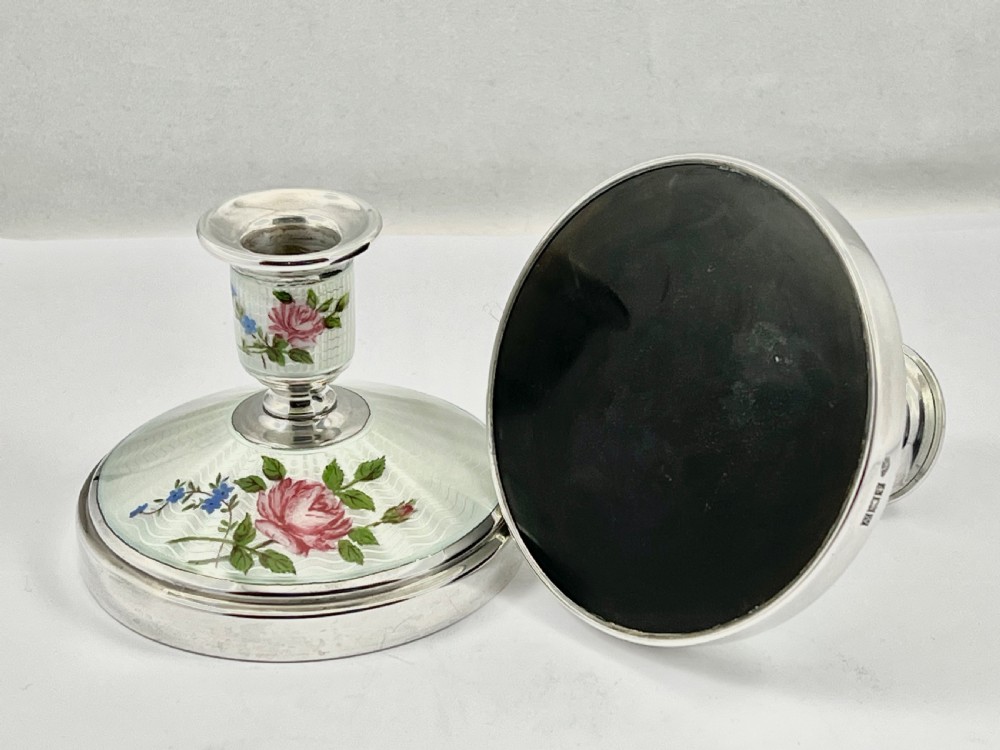 A pair of Elizabeth II sterling silver candlesticks featuring engine-turned white enamel bases and stems adorned with painted pink roses. View VII