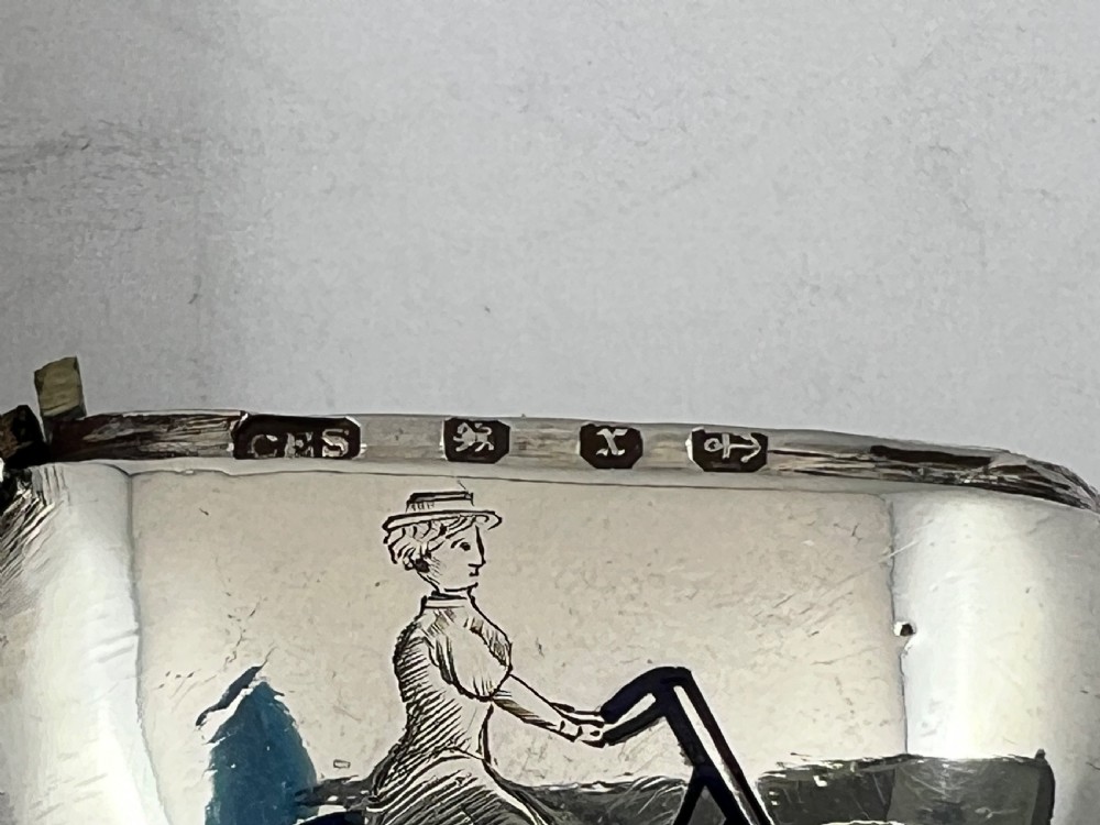 A heart-shaped sterling silver vesta case featuring an enamelled illustration of a female cyclist. View VI