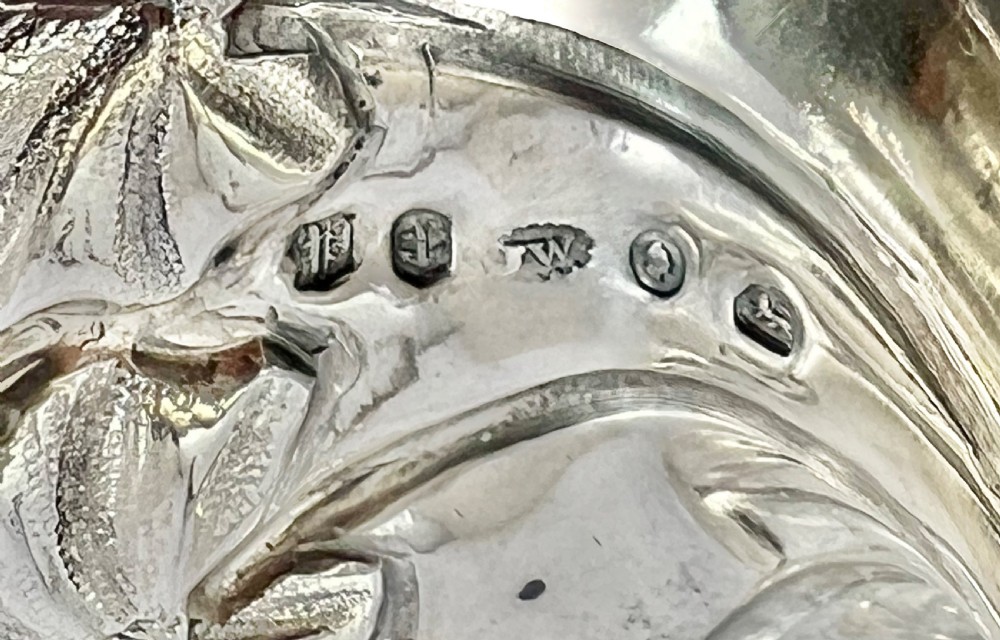 An early Victorian sterling silver chamberstick featuring a naturalistic leaf-shaped tray base, textured stem, twig handle, and removable conical leaf snuffer. View XII