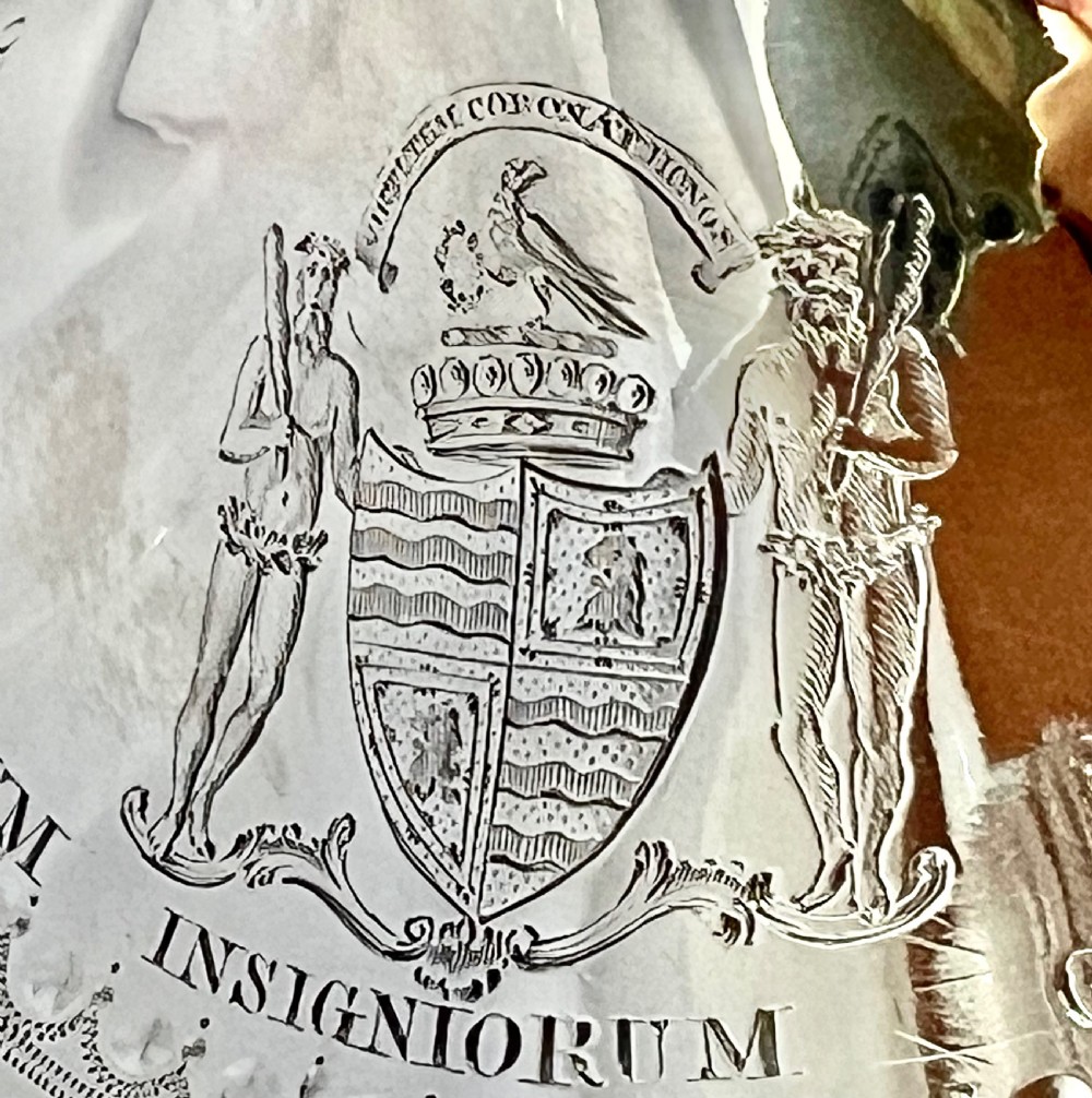 A George III two-handled sterling silver cup with bright-cut engraving, an armorial crest, and a stepped circular pedestal base. View VII