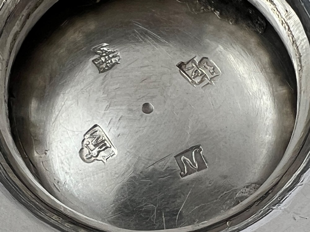 A George II Scottish sterling silver bullet teapot featuring chased foliage along the shoulder, a wooden scroll handle, and a raised pedestal base. View XI