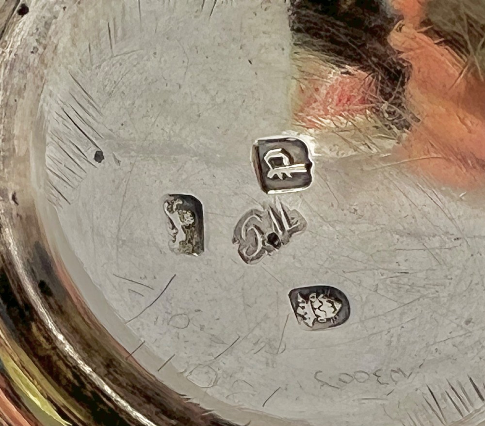 A Georgian sterling silver pint tankard featuring a baluster-shaped body, double-scroll handle, and a moulded circular foot. View IX