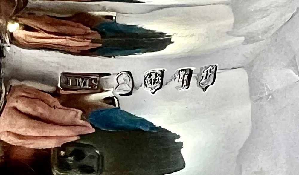A William IV sterling silver water jug featuring a hinged domed lid, acanthus leaf relief carving, engraved monogram, and an angular insulated handle. View VIII