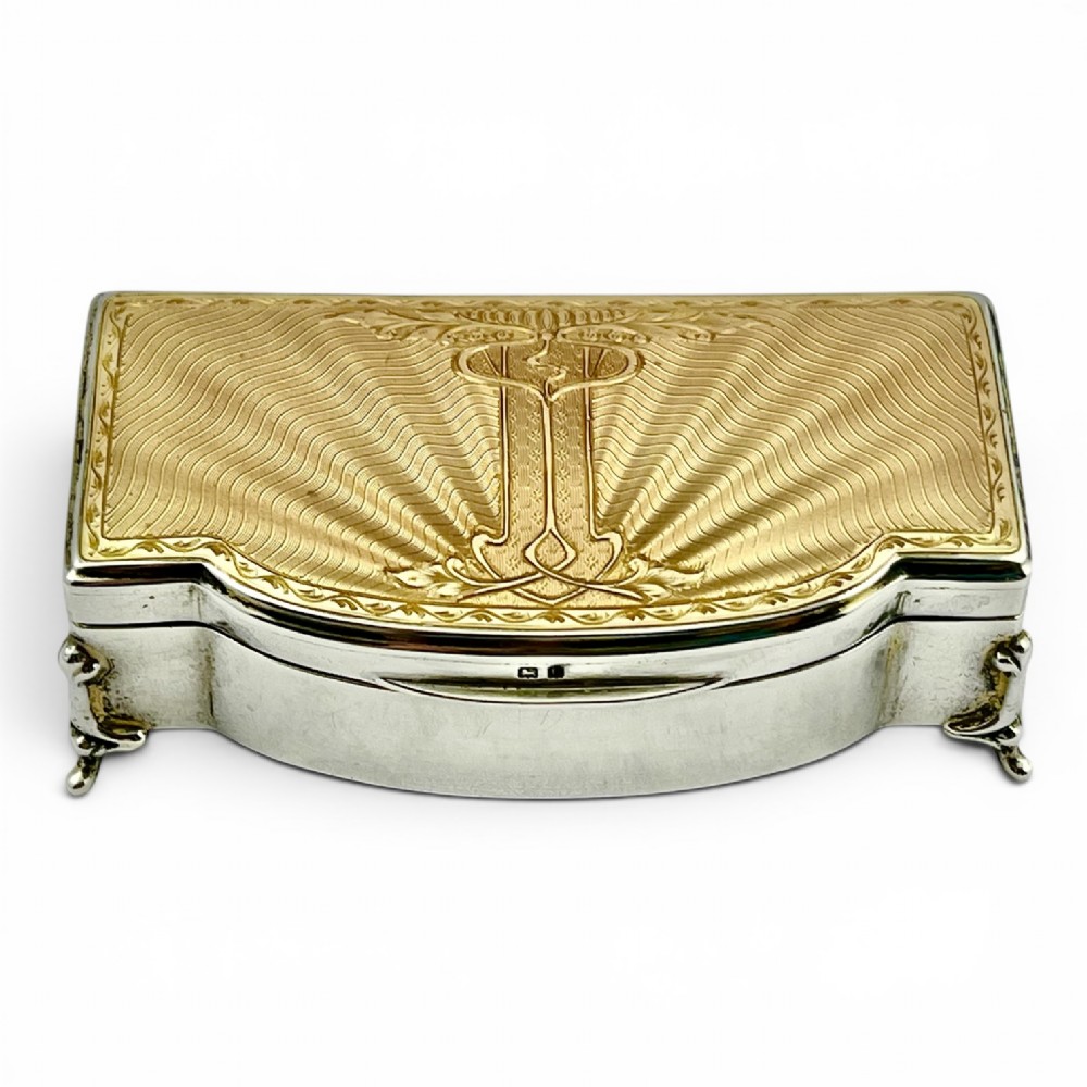 An Art Deco sterling silver jewellery box featuring a yellow guilloche enamel lid with engine-turned geometric patterns and decorative corner feet.