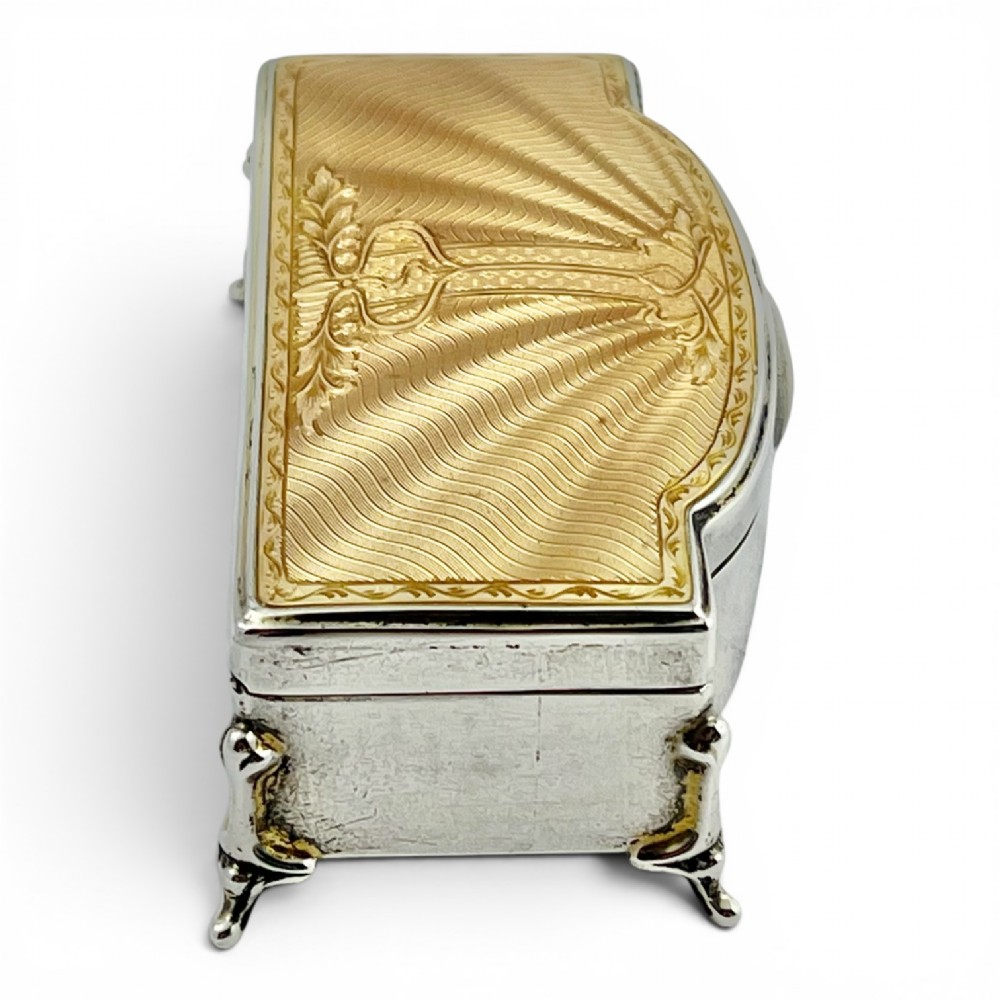 An Art Deco sterling silver jewellery box featuring a yellow guilloche enamel lid with engine-turned geometric patterns and decorative corner feet. View II