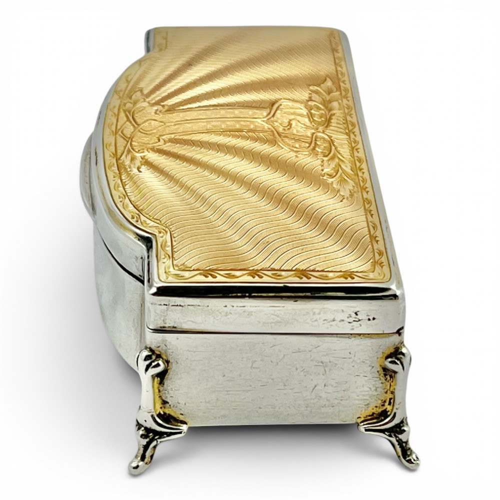 An Art Deco sterling silver jewellery box featuring a yellow guilloche enamel lid with engine-turned geometric patterns and decorative corner feet. View IV