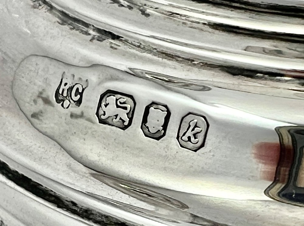 A sterling silver three-branch candelabra featuring a central baluster column, curved reeded arms, circular drip pans, and a stepped circular base. View VII