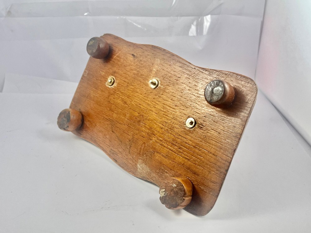A Victorian carved oak inkstand featuring a central silver stag head mount, twin cut glass inkwells, silver pen rests, and a carved Celtic knotwork border. View IX