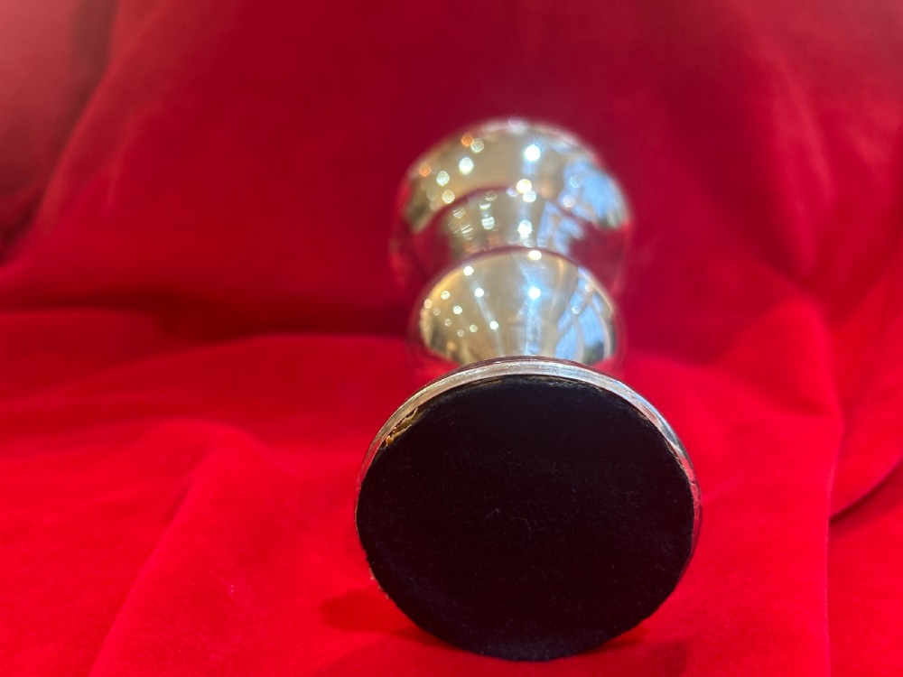 An Edwardian silver trumpet vase with a scalloped flared rim, bulbous lower stem section, and stepped circular pedestal base. View IV