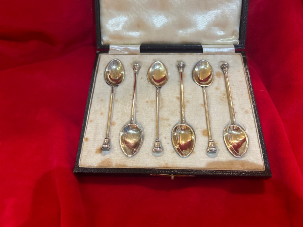 A cased set of six silver spoons featuring vibrant, colourful guilloche enamel bowls housed inside a satin-lined fitted presentation box. View II