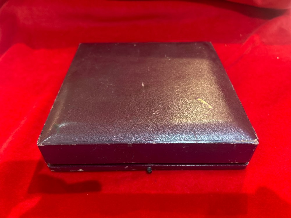 A set of four die-stamped silver open salt cellars with gilt interiors and matching salt spoons, arranged inside a fitted velvet-lined presentation case. View V