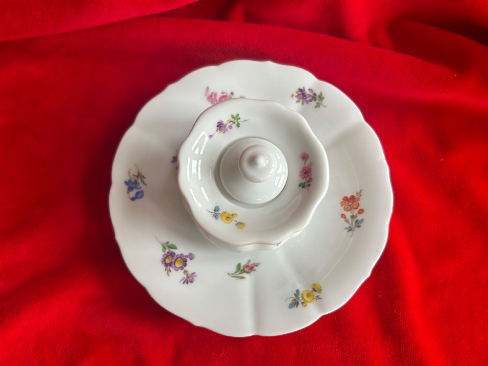 A white Meissen porcelain inkwell featuring hand-painted floral sprigs, a scalloped base plate, fluted inkwell body, and fitted porcelain lid with finial. View II