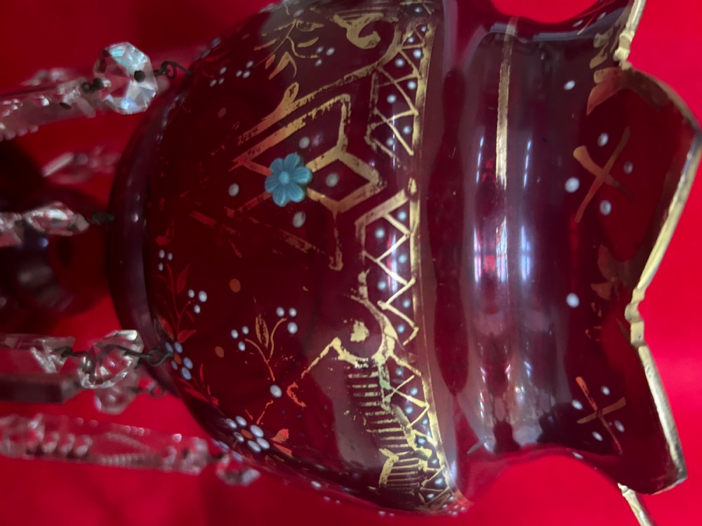 A pair of Victorian ruby glass mantel lustres featuring scalloped edges, hand-painted floral enamel, gilding, and suspended cut crystal prisms. View VI