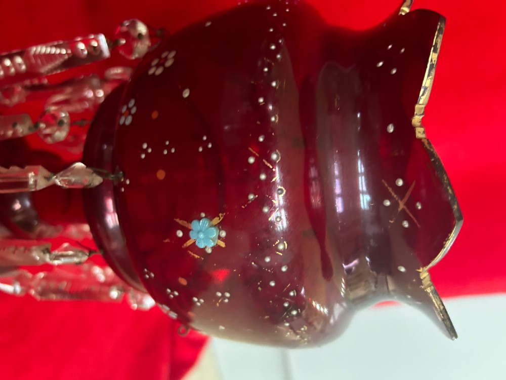 A pair of Victorian ruby glass mantel lustres featuring scalloped edges, hand-painted floral enamel, gilding, and suspended cut crystal prisms. View VII