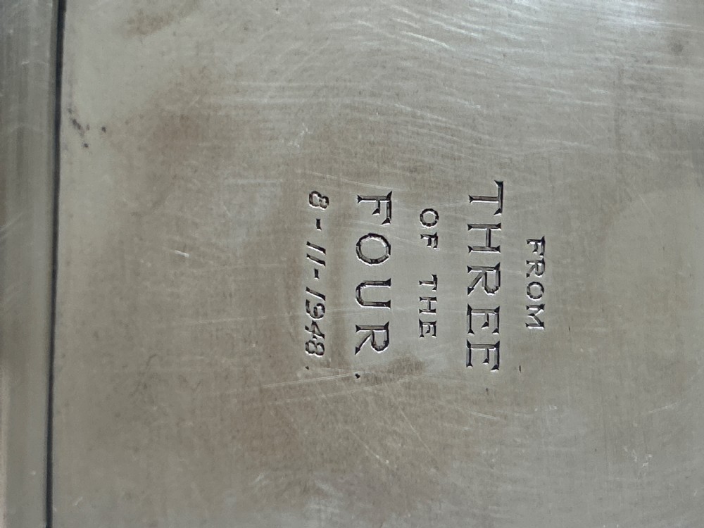 A small square silver dish featuring scalloped edges and engraved lettering dated 1948 in the centre. View IV