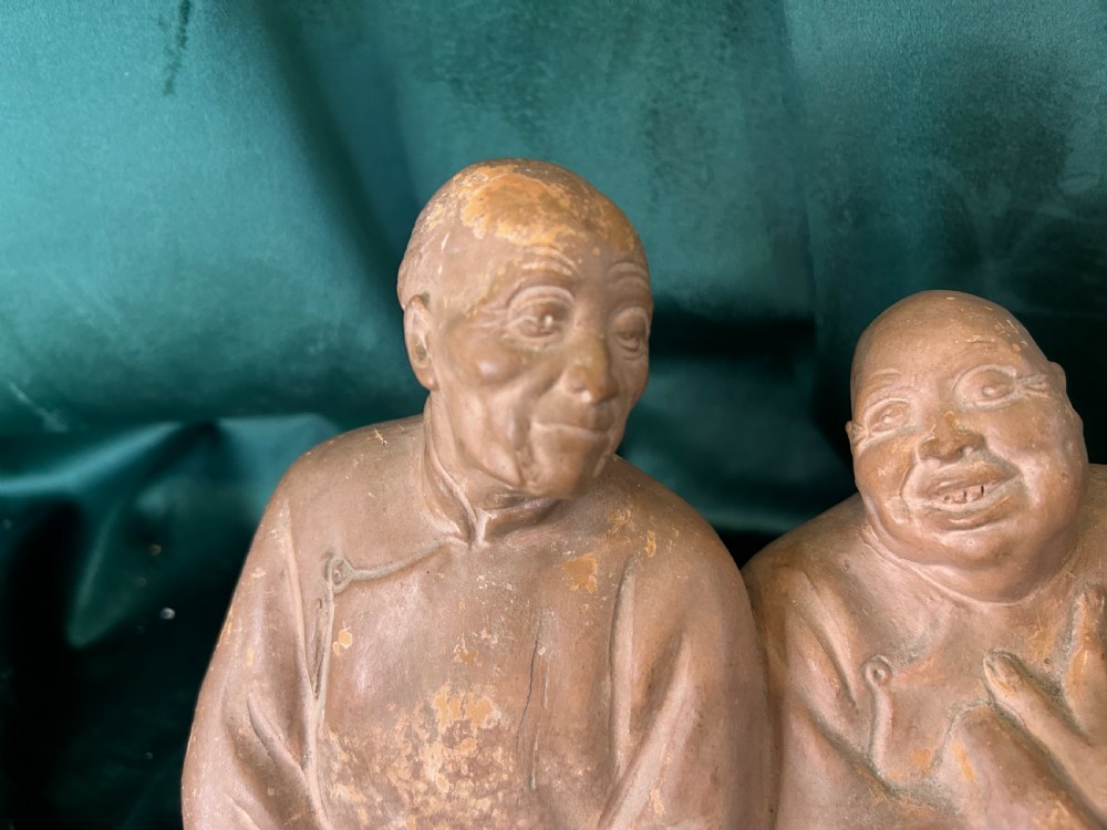 An Art Deco terracotta sculpture depicting three expressive figures mounted on a black marble base. View II